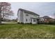 A spacious backyard featuring a well-maintained lawn, a back deck, a patio, and mature trees at 8941 Vickery Ln, Harrisburg, NC 28075