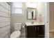 This functional bathroom features a decorative mirror, vanity with a dark wood cabinet, and a shower/tub combo at 8941 Vickery Ln, Harrisburg, NC 28075
