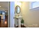 Traditional powder room with pedestal sink, framed mirror, and decorative plant at 8941 Vickery Ln, Harrisburg, NC 28075