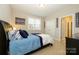 A bedroom with sport themed decorations, a ceiling fan, closet, and carpet floors at 8941 Vickery Ln, Harrisburg, NC 28075