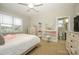 Bright bedroom featuring a vanity, ceiling fan, and ample natural light at 8941 Vickery Ln, Harrisburg, NC 28075