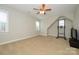 This open bonus room provides versatile space with neutral paint, a ceiling fan, and natural light at 8941 Vickery Ln, Harrisburg, NC 28075