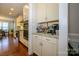 Convenient coffee bar area with custom cabinets, granite countertop, and modern appliances at 8941 Vickery Ln, Harrisburg, NC 28075