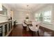 Elegant dining room featuring hardwood floors, tray ceilings, and a modern chandelier at 8941 Vickery Ln, Harrisburg, NC 28075