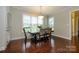 Dining room with hardwood floors, natural light, and seating for four at 8941 Vickery Ln, Harrisburg, NC 28075