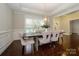 Bright dining room with hardwood floors, tray ceilings, and views of the front yard at 8941 Vickery Ln, Harrisburg, NC 28075
