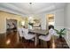 Elegant dining room with hardwood floors and an open layout to the exercise room at 8941 Vickery Ln, Harrisburg, NC 28075