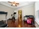 Bright exercise room featuring hardwood floors, a ceiling fan, and ample space at 8941 Vickery Ln, Harrisburg, NC 28075