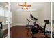 Home exercise room with hardwood floors, ceiling fan, and workout equipment at 8941 Vickery Ln, Harrisburg, NC 28075