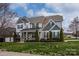 Stunning two-story home featuring manicured landscaping and a charming front porch at 8941 Vickery Ln, Harrisburg, NC 28075