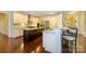 Spacious kitchen with stainless steel appliances, granite countertops, and dark wood flooring at 8941 Vickery Ln, Harrisburg, NC 28075