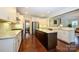 Bright kitchen with stainless steel appliances, granite countertops, and hardwood floors at 8941 Vickery Ln, Harrisburg, NC 28075
