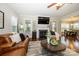 Open living room with fireplace, television, and view of the dining area at 8941 Vickery Ln, Harrisburg, NC 28075
