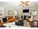 Cozy living room featuring comfortable seating, a fireplace, and natural light at 8941 Vickery Ln, Harrisburg, NC 28075
