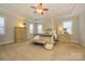This main bedroom has tray ceiling and matching dressers on both sides of bed at 8941 Vickery Ln, Harrisburg, NC 28075