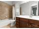 Well-lit bathroom featuring a shower-tub combination, a wooden vanity, and neutral-toned tile at 917 Herrons Ferry Rd, Rock Hill, SC 29730