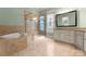 Bright bathroom featuring a soaking tub, glass shower, tile floors, and a double vanity at 917 Herrons Ferry Rd, Rock Hill, SC 29730