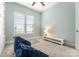 Bright bedroom with a ceiling fan, two large windows, and cozy seating for relaxation at 917 Herrons Ferry Rd, Rock Hill, SC 29730