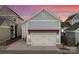 Stylish two-car garage with carriage doors on a home with light blue siding and a red awning at 917 Herrons Ferry Rd, Rock Hill, SC 29730