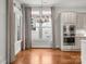 Kitchen nook features hardwood floors and modern lighting adjacent to stainless-steel appliances at 917 Herrons Ferry Rd, Rock Hill, SC 29730