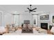 Cozy living room features a fireplace, hardwood floors, and ceiling fan; the perfect place to relax at 917 Herrons Ferry Rd, Rock Hill, SC 29730