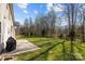Large backyard with mature trees and concrete patio perfect for outdoor entertaining at 10129 Loch Lomond Dr, Charlotte, NC 28278