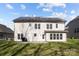 View of the back of house with solar panels and a well maintained yard and patio at 10129 Loch Lomond Dr, Charlotte, NC 28278