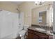 Relaxing bathroom with a tub/shower, granite-topped vanity, and a view out into the hallway at 10129 Loch Lomond Dr, Charlotte, NC 28278
