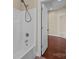 Well-lit bathroom with a bathtub and shower combination, and a view into the hallway of the home at 10129 Loch Lomond Dr, Charlotte, NC 28278