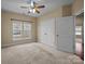 Serene bedroom with soft carpet, large windows, and adjacent closet space to keep you organized at 10129 Loch Lomond Dr, Charlotte, NC 28278