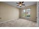 A bedroom with neutral walls, carpet, a ceiling fan and one window allowing for natural light at 10129 Loch Lomond Dr, Charlotte, NC 28278