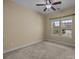 Bright bedroom with neutral carpet, ceiling fan and a large window with a neighborhood view at 10129 Loch Lomond Dr, Charlotte, NC 28278