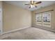 Comfortable bedroom with neutral carpet and a ceiling fan, plus natural light from the windows at 10129 Loch Lomond Dr, Charlotte, NC 28278