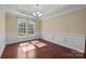 Formal dining room featuring beautiful moldings, a chandelier, and large windows that provide ample natural light at 10129 Loch Lomond Dr, Charlotte, NC 28278