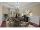 This is a virtual rendering of a dining room boasting a wooden table, stylish chairs, and elegant decor at 10129 Loch Lomond Dr, Charlotte, NC 28278