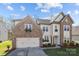 Beautiful two-story home with stone accents, attached garage, and manicured landscaping at 10129 Loch Lomond Dr, Charlotte, NC 28278