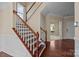 The foyer showcases a staircase, hardwood floors, and a view into the living room at 10129 Loch Lomond Dr, Charlotte, NC 28278