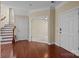 The home's foyer features hardwood floors, a staircase, access to other rooms, and a front door with a secure lock at 10129 Loch Lomond Dr, Charlotte, NC 28278