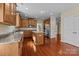 Kitchen with island, granite counters, stainless appliances, custom cabinets and hardwood floors at 10129 Loch Lomond Dr, Charlotte, NC 28278