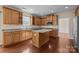 Well-lit kitchen with granite countertops, stainless appliances, custom cabinets, and hardwood floors at 10129 Loch Lomond Dr, Charlotte, NC 28278