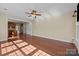 Open-concept living room with beautiful hardwood floors and neutral paint, perfect for entertaining at 10129 Loch Lomond Dr, Charlotte, NC 28278