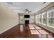 Bright living room featuring hardwood floors, many windows, and a cozy fireplace at 10129 Loch Lomond Dr, Charlotte, NC 28278