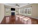 Living room filled with natural light featuring hardwood floors and a cozy fireplace at 10129 Loch Lomond Dr, Charlotte, NC 28278
