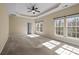 Spacious main bedroom featuring tray ceilings, carpet flooring, and large windows allowing ample natural light at 10129 Loch Lomond Dr, Charlotte, NC 28278