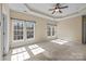 Spacious main bedroom featuring tray ceilings, carpet flooring, and large windows allowing ample natural light at 10129 Loch Lomond Dr, Charlotte, NC 28278