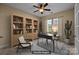 This is a virtual rendering of a home office space with neutral walls, a stylish desk, and built-in shelving at 10129 Loch Lomond Dr, Charlotte, NC 28278