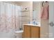 Bathroom with a floral shower curtain, built in shelves, and a light wood vanity at 105 Easy St, Mooresville, NC 28117