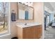 Bathroom featuring a large mirror, a white countertop, wood cabinets, and a blue accent wall at 105 Easy St, Mooresville, NC 28117