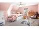 Bedroom with pink walls, a ceiling fan, natural lighting, and pink furniture at 105 Easy St, Mooresville, NC 28117