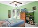 This bedroom features bright green walls, a ceiling fan, a TV, and an aquarium at 105 Easy St, Mooresville, NC 28117
